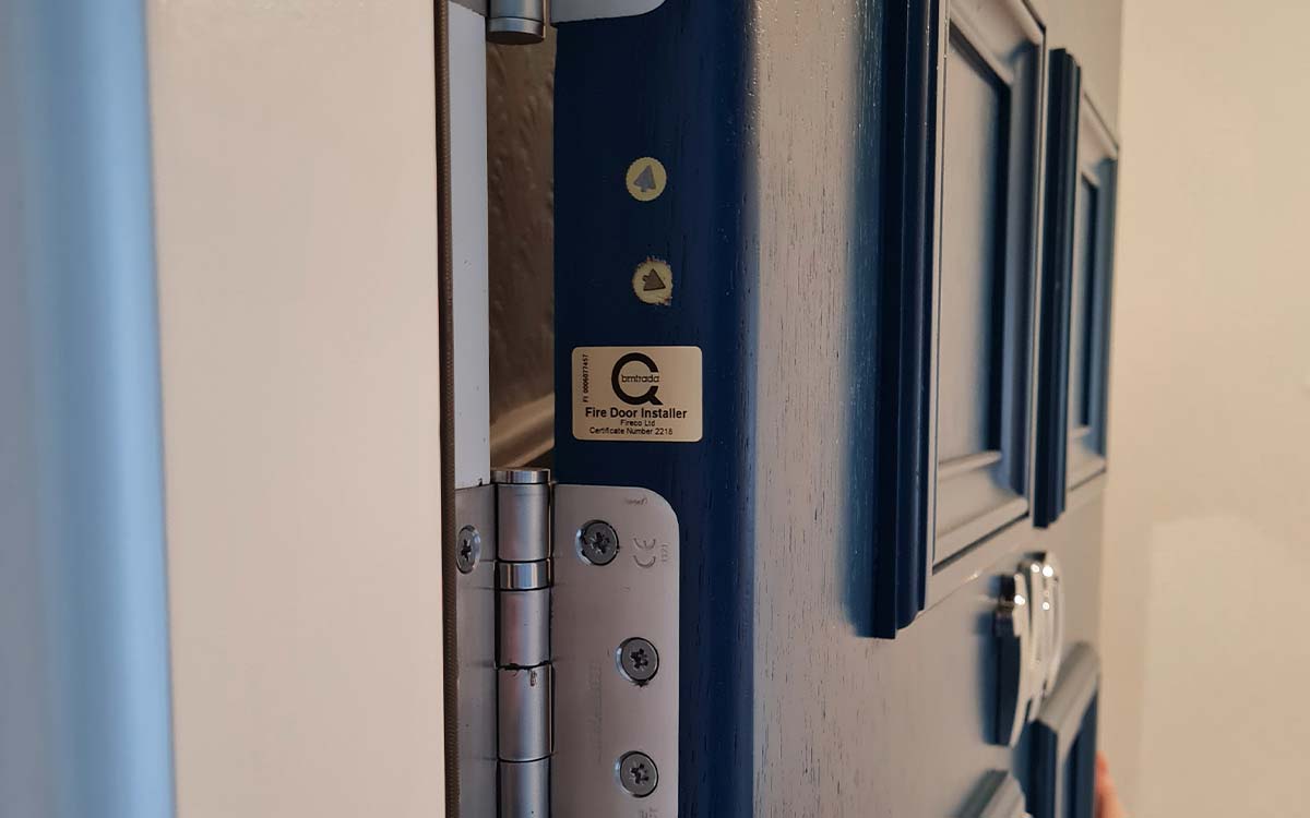 Blue fire door with BM TRADA accreditation sticker