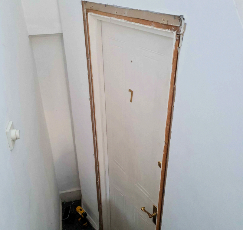 The original door at Paul's flat. A white door with the door frame removed.