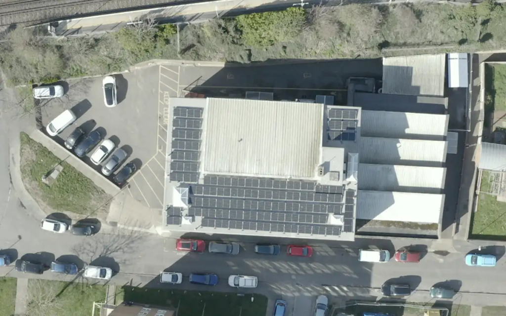 An overhad drone shot looking down at the solar panels on the roof of the Fireco offices