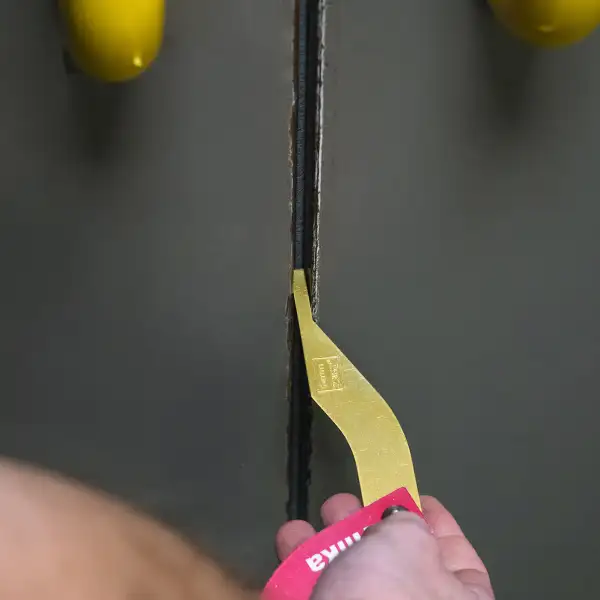 A gap measurement tool being used to measure the gap between two doors (as part of a double doorset)