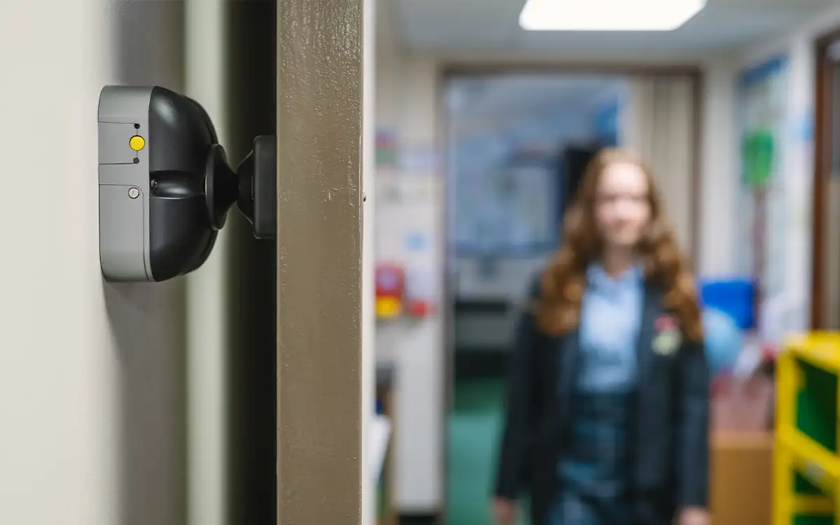 DorMag fire door magnet holding open a fire door in a school corridor