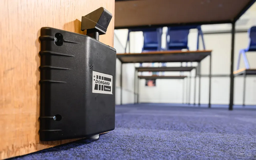 A Dorgard keeping a fire door open in a school
